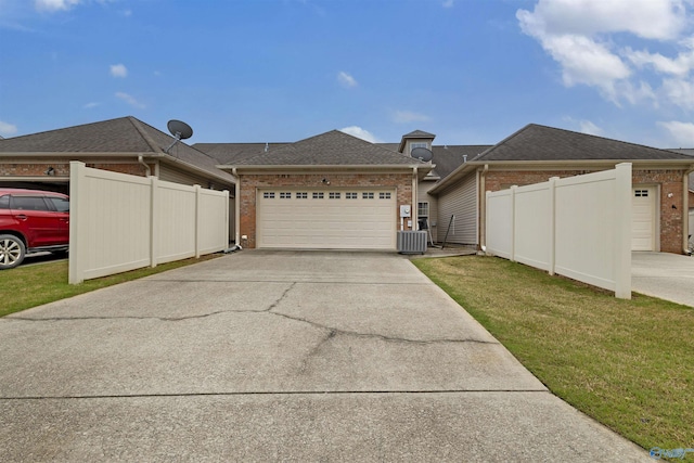 single story home with brick siding, a garage, fence, and concrete driveway