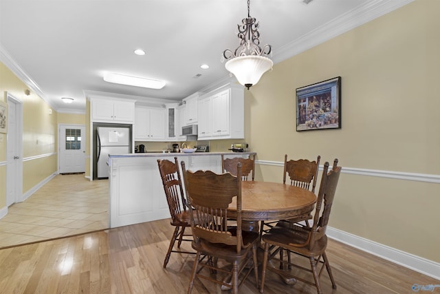 dining area with baseboards, ornamental molding, light wood finished floors, and recessed lighting
