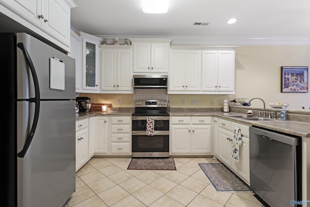 kitchen with white cabinets, a sink, stainless steel appliances, light tile patterned floors, and visible vents
