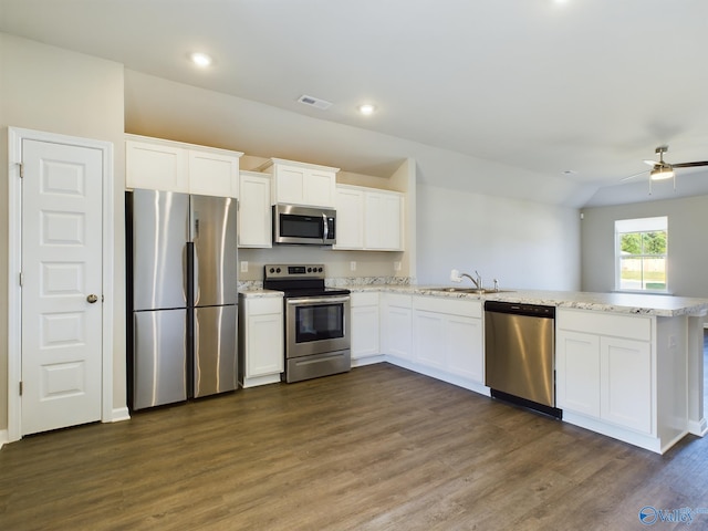 kitchen featuring white cabinetry, kitchen peninsula, appliances with stainless steel finishes, and dark hardwood / wood-style flooring