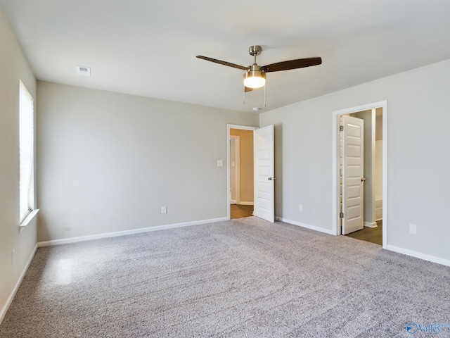 empty room featuring carpet flooring, ceiling fan, and plenty of natural light