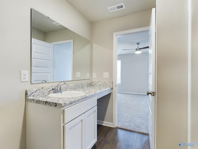 bathroom featuring vanity, hardwood / wood-style floors, and ceiling fan