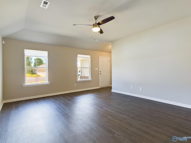 unfurnished room with dark hardwood / wood-style flooring, vaulted ceiling, and ceiling fan