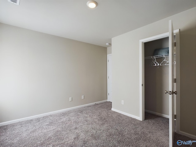 unfurnished bedroom featuring a closet and carpet floors