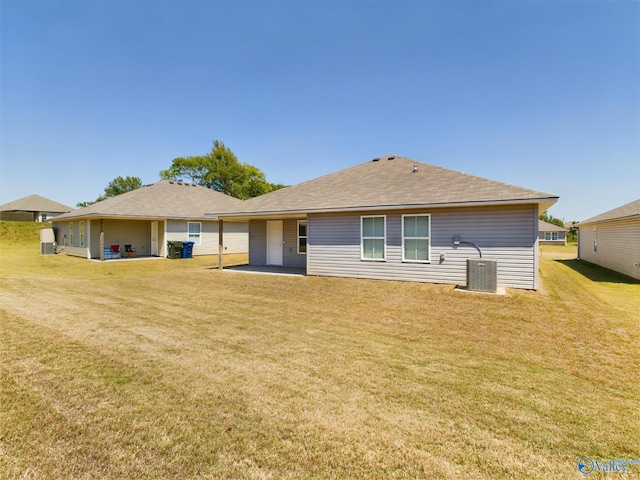 rear view of property with a patio and a lawn