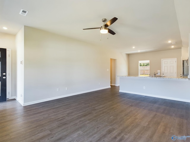 unfurnished living room featuring ceiling fan and dark hardwood / wood-style flooring