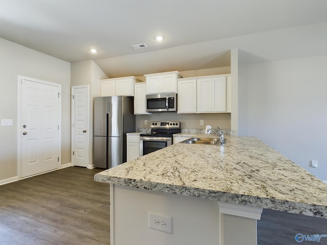 kitchen featuring white cabinets, dark hardwood / wood-style flooring, sink, and appliances with stainless steel finishes