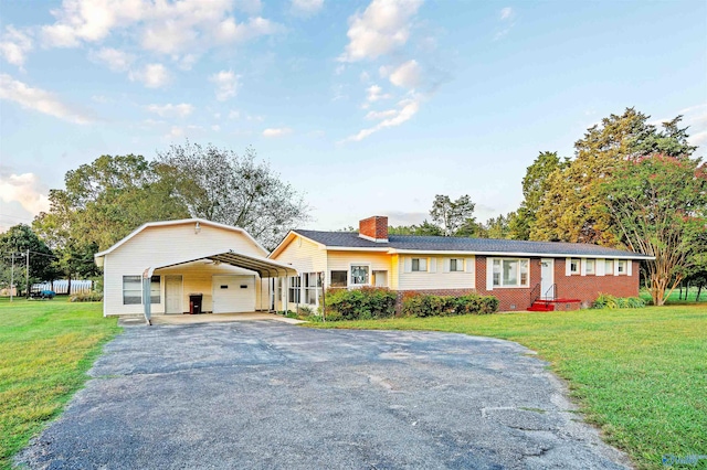 ranch-style home featuring a garage and a front lawn