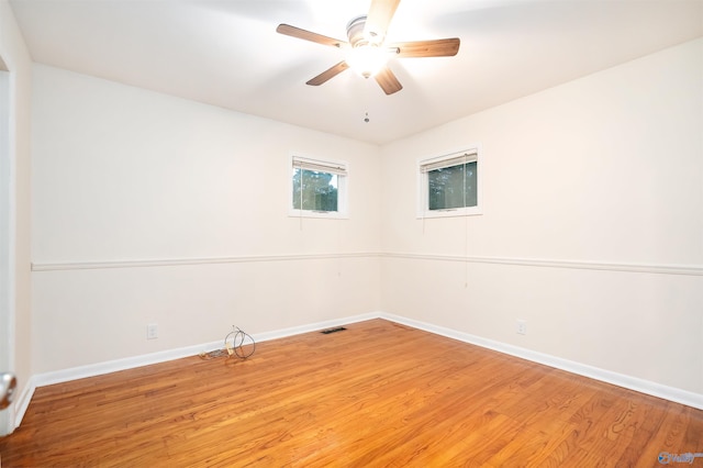 spare room with wood-type flooring and ceiling fan