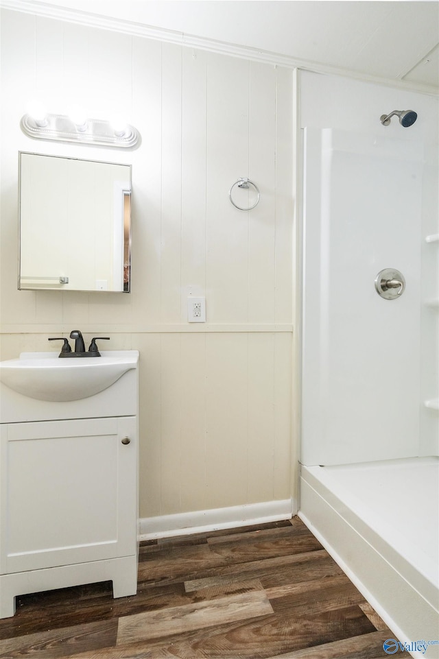 bathroom with wood-type flooring, vanity, and shower / bathtub combination