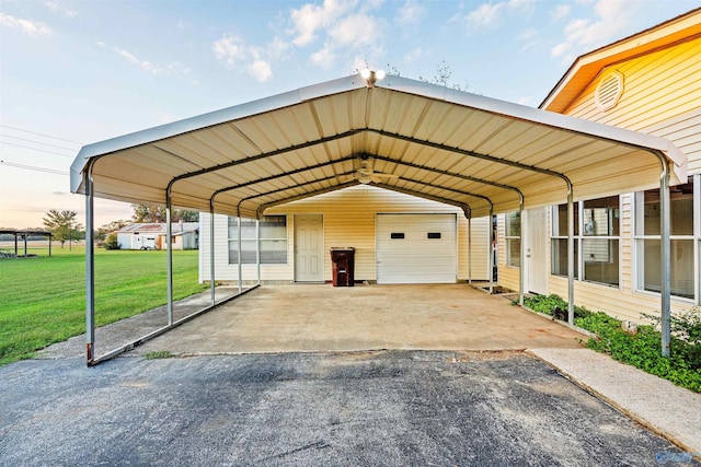 parking at dusk featuring a garage, a lawn, and a carport