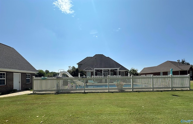 view of swimming pool with a lawn and a water slide