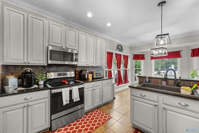 2224 Veranda Trce, Gadsden, AL 35903 - kitchen featuring stainless steel appliances, a sink, dark countertops, light tile patterned floors, and tasteful backsplash