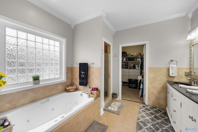 bathroom with ornamental molding, vanity, separate shower and tub, and tile patterned floors