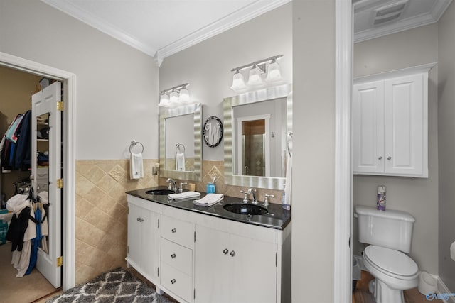 2224 Veranda Trce, Gadsden, AL 35903 - bathroom with tile walls, crown molding, double vanity, toilet, and a wainscoted wall