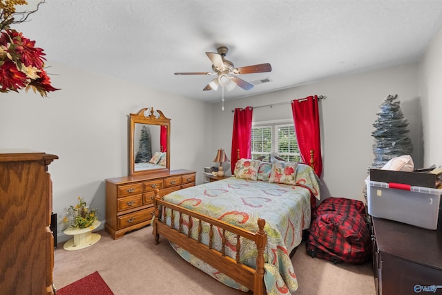 bedroom featuring ceiling fan and light colored carpet