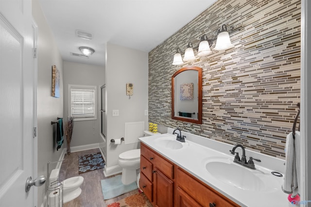 2224 Veranda Trce, Gadsden, AL 35903 - bathroom with toilet, decorative backsplash, double vanity, wood finished floors, and bath / shower combo with glass door