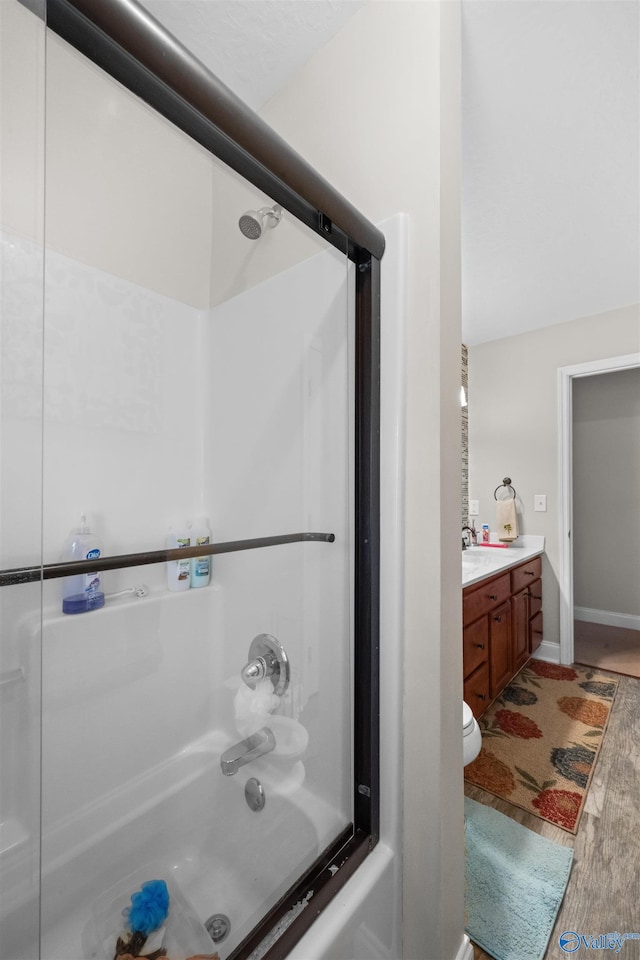 full bathroom featuring tub / shower combination, vanity, and toilet