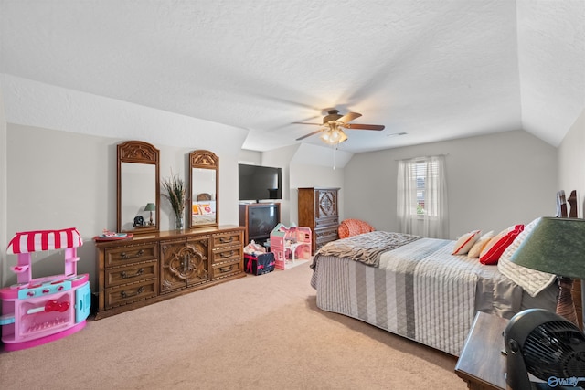 bedroom with ceiling fan, a textured ceiling, vaulted ceiling, and carpet