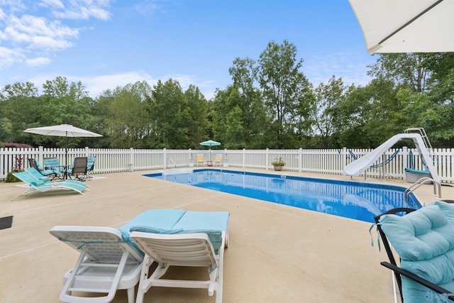 2224 Veranda Trce, Gadsden, AL 35903 - view of swimming pool featuring a patio, a water slide, a fenced backyard, and view of scattered trees