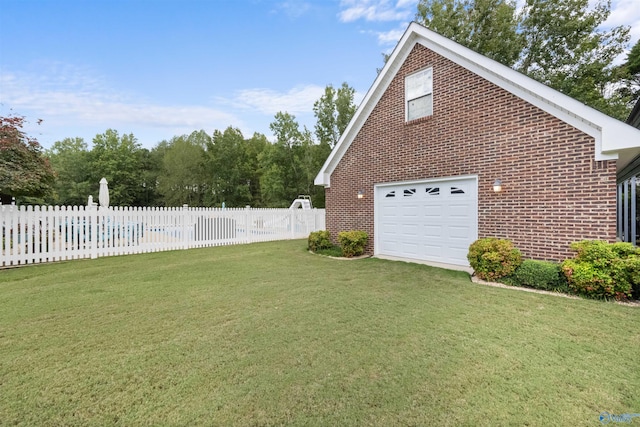 view of home's exterior with a yard and a garage