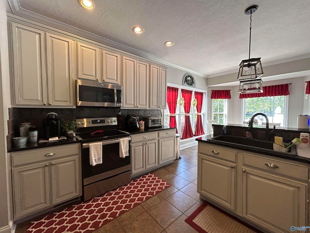 kitchen featuring hanging light fixtures, cream cabinetry, decorative backsplash, appliances with stainless steel finishes, and crown molding