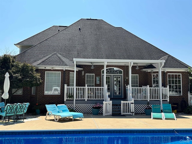 back of property with a patio area and a swimming pool side deck