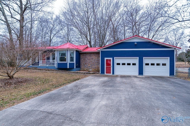 ranch-style home with a garage and covered porch