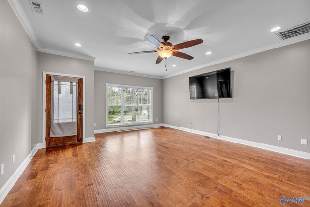 empty room with ceiling fan, ornamental molding, and light hardwood / wood-style floors