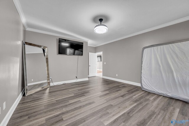 interior space with hardwood / wood-style flooring and ornamental molding