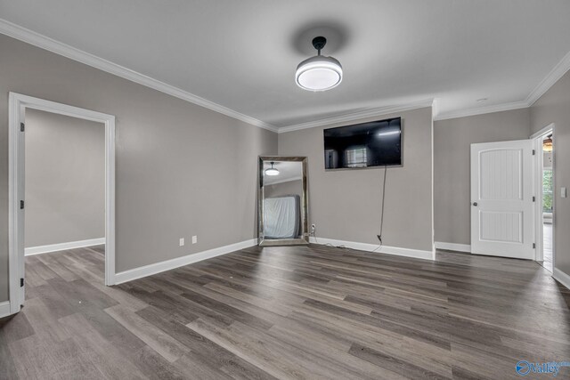 unfurnished living room with crown molding and hardwood / wood-style floors