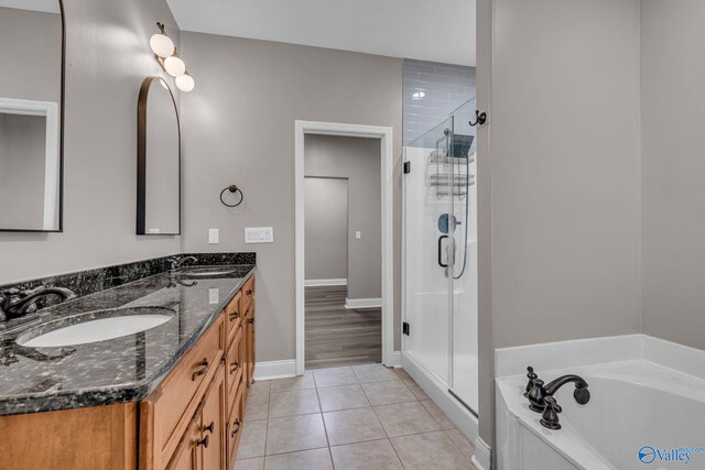 bathroom with tile patterned flooring, vanity, and separate shower and tub