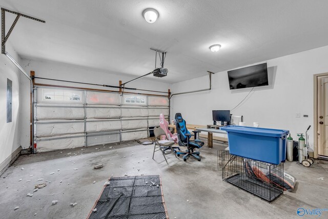 garage with a garage door opener and electric panel