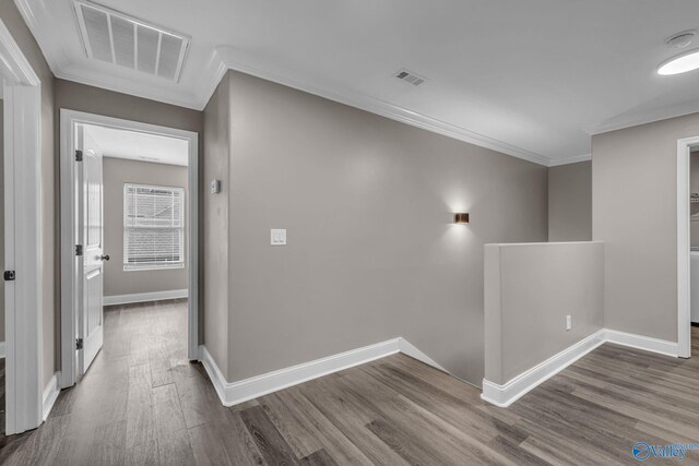 hallway featuring ornamental molding and hardwood / wood-style flooring