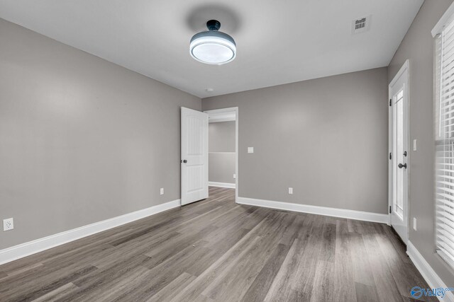 unfurnished room featuring hardwood / wood-style flooring