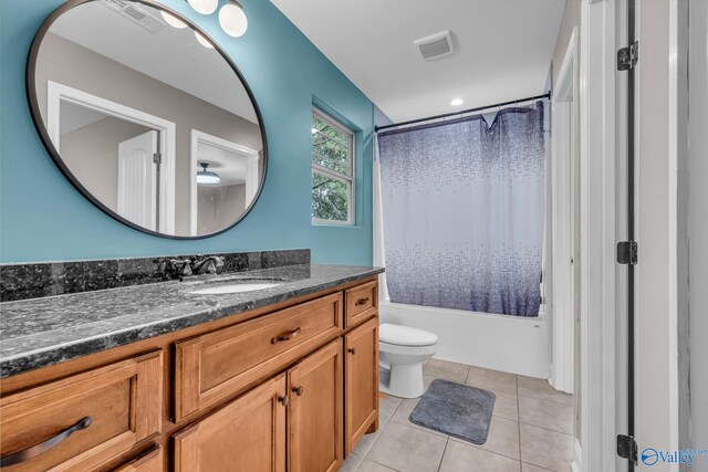 full bathroom featuring vanity, toilet, tile patterned floors, and shower / bath combination with curtain