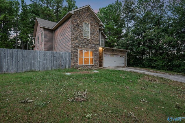 view of front facade with a yard and a garage