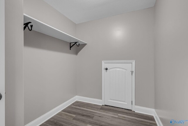 interior space featuring a textured ceiling and hardwood / wood-style floors