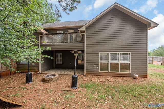 rear view of property with a patio and a balcony