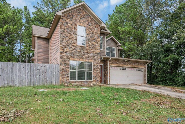 view of front of property featuring a garage and a front yard