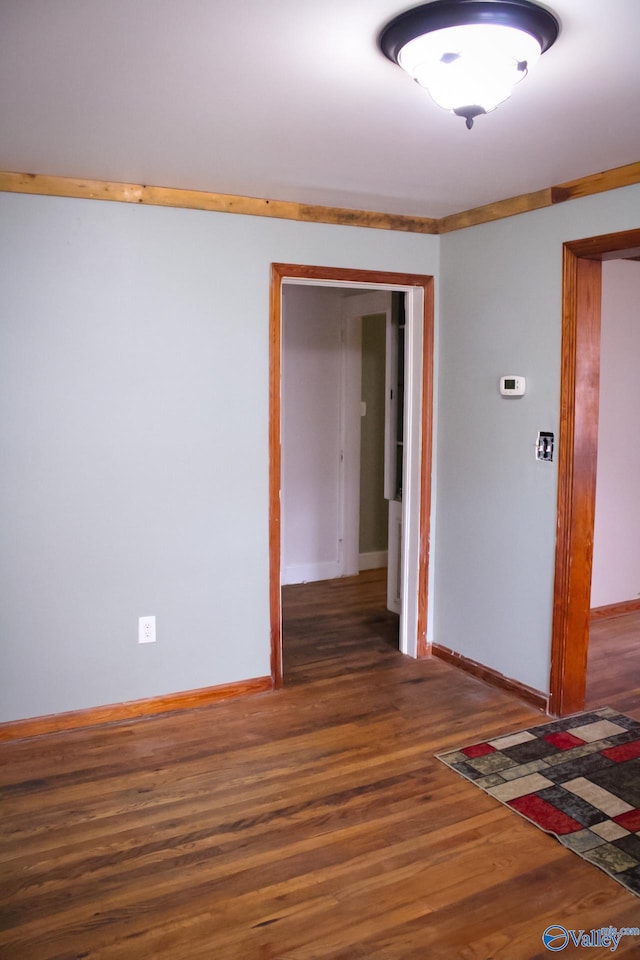 empty room featuring dark hardwood / wood-style flooring