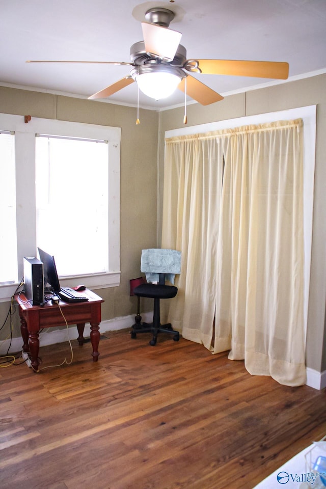 sitting room featuring wood-type flooring and ceiling fan