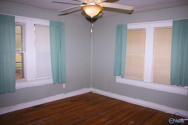 spare room featuring ceiling fan, dark hardwood / wood-style flooring, and crown molding