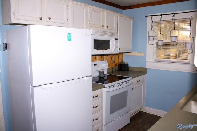 kitchen with white cabinets, dark hardwood / wood-style floors, white appliances, and ornamental molding