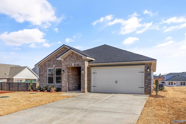 ranch-style house featuring a garage and central AC