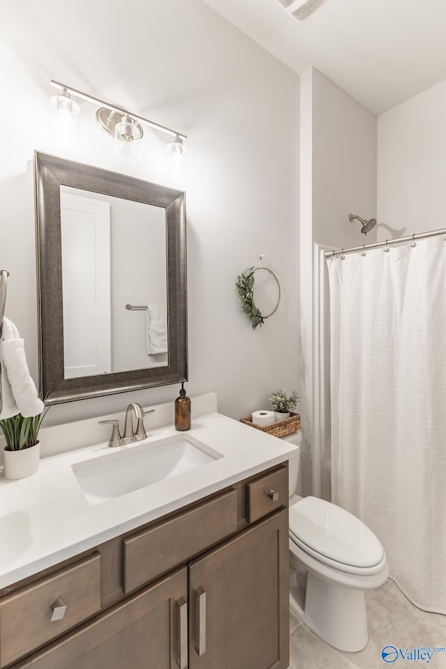 bathroom featuring vanity, toilet, and tile patterned floors