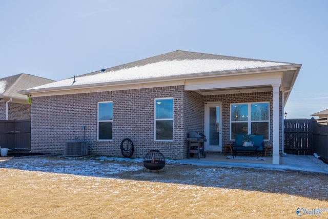 back of house with brick siding, a patio area, cooling unit, and fence