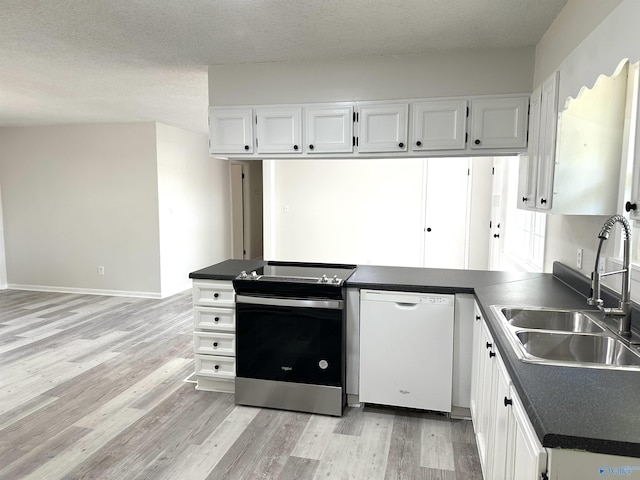 kitchen featuring stainless steel electric range, dark countertops, light wood-style floors, dishwasher, and a sink