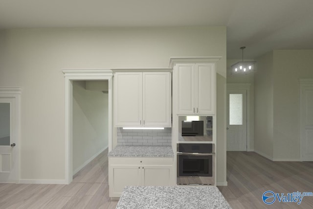 kitchen featuring white cabinetry, oven, light wood-type flooring, and decorative backsplash