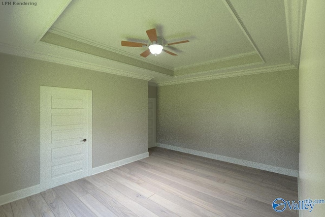 spare room with ceiling fan, a raised ceiling, and light hardwood / wood-style floors